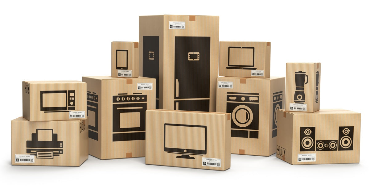 Stacked cardboard boxes labeled with illustrations of electronics like monitors, printers, stereos, laptops, and more.