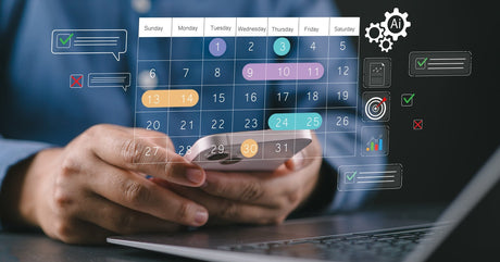 Someone sits in front of a laptop and holds a smartphone. A calendar and notification graphic hovers over the smartphone.